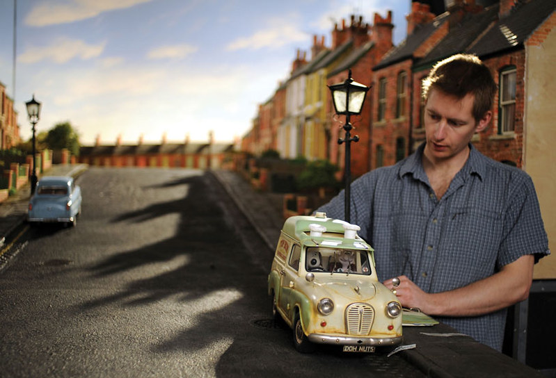 an man animating a car on a stop motion set
